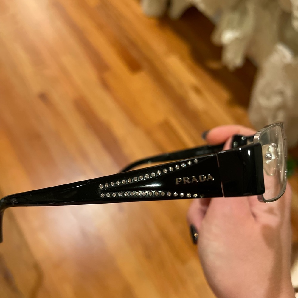 Never been worn pair of Prada glasses with diamond in side.